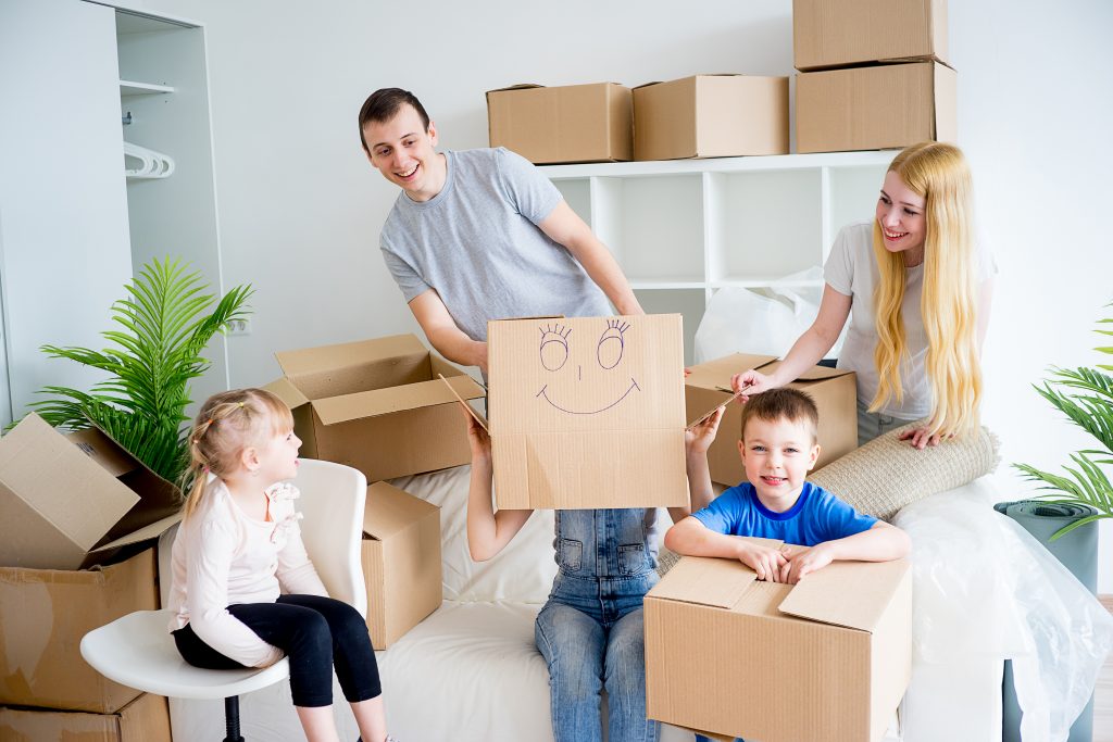 Young family unpacking boxes after they moved into new house