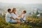 Happy parents and their little girl rest on the lawn How to Show Love and Affection to Your Family Each and Every Day