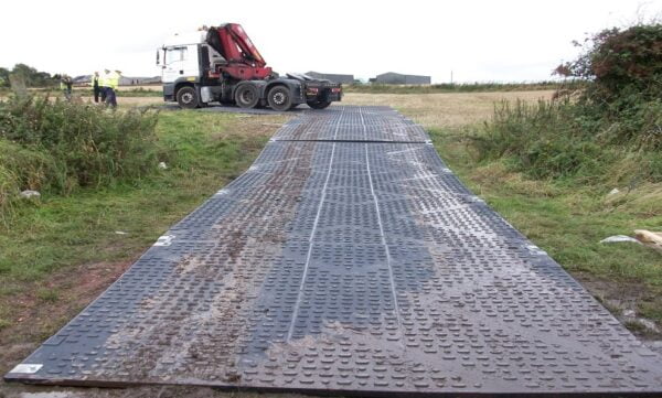 Why do you need to utilize temporary road construction mats?